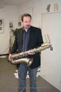 A photograph of Andreas with the baritone saxophone