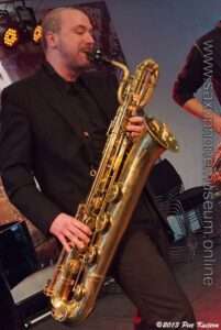 Photo of the saxophone being played in a band
