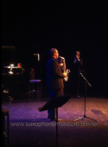 Photo of a man playing the saxophone on stage