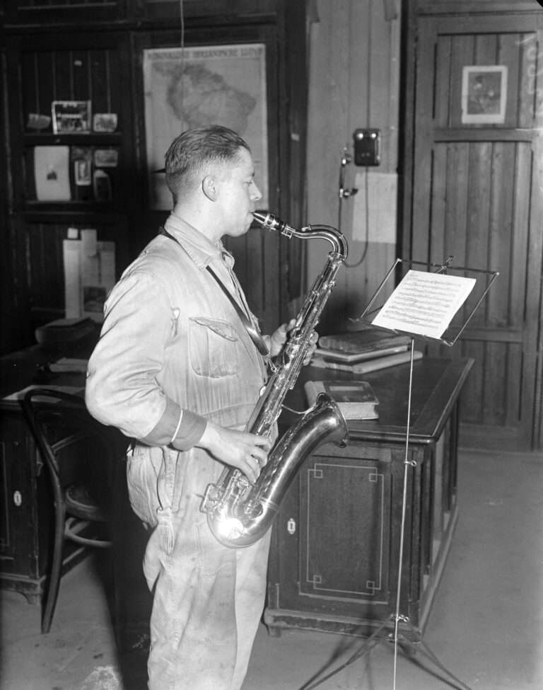 A photograph of a Kessels employee testing a saxophone.